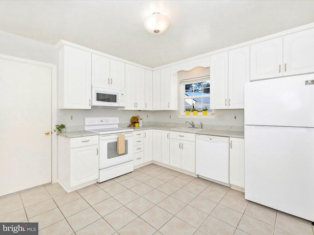 kitchen featuring white cabinets, white appliances, sink, and light tile patterned floors