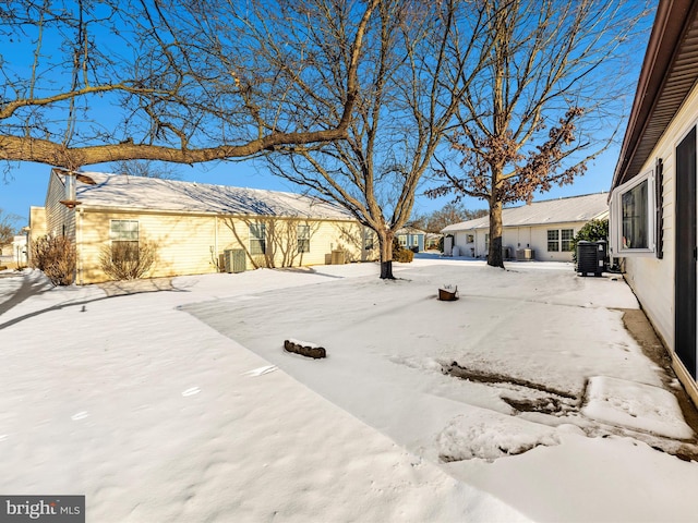 snowy yard featuring cooling unit