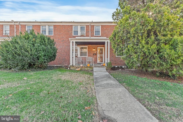 multi unit property with a front yard and covered porch