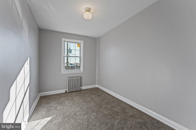 unfurnished room featuring carpet and radiator heating unit