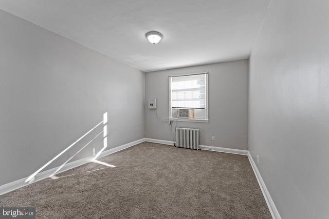 carpeted empty room with radiator