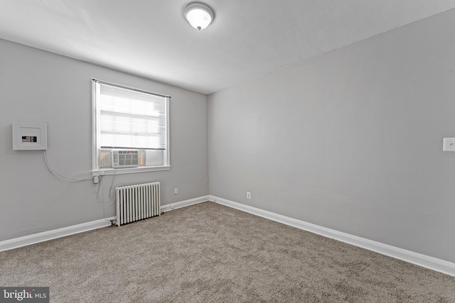 unfurnished room featuring carpet flooring, cooling unit, and radiator