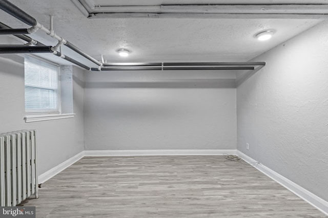 spacious closet with radiator and hardwood / wood-style flooring