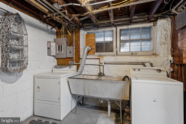 clothes washing area featuring washer and dryer, sink, and electric panel