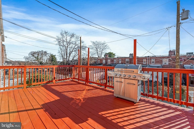 wooden deck with a grill