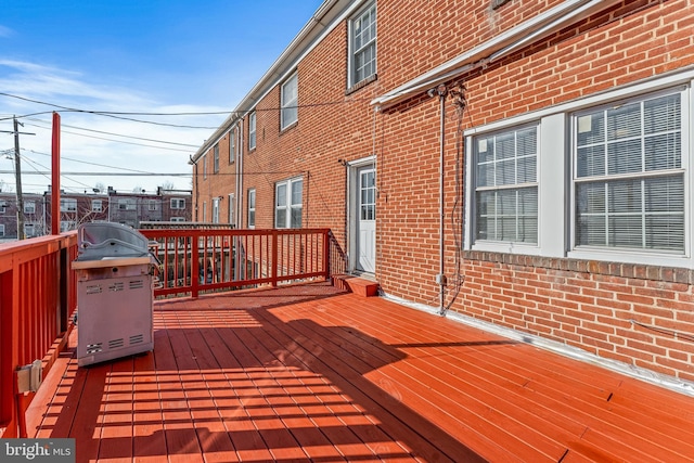 wooden terrace featuring a grill