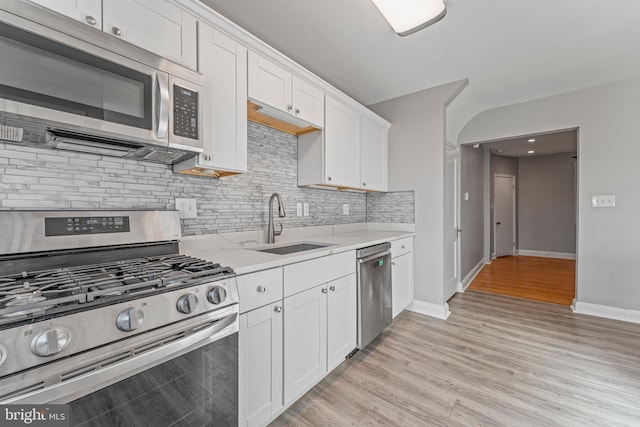 kitchen with white cabinets, stainless steel appliances, and sink