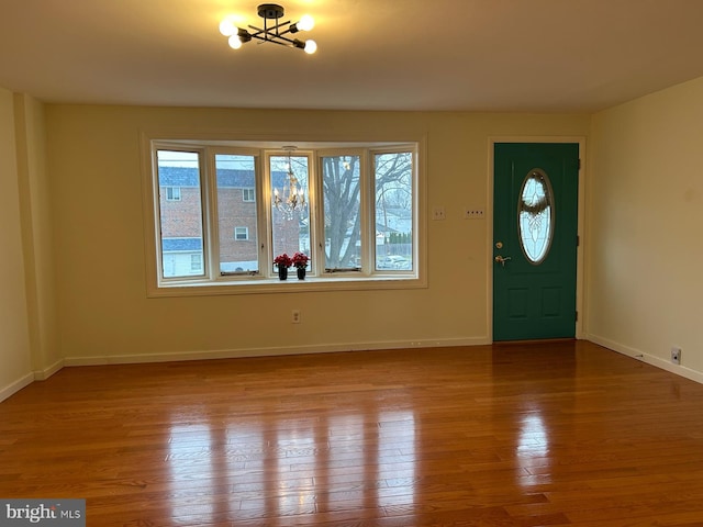 entryway with a chandelier and light hardwood / wood-style floors