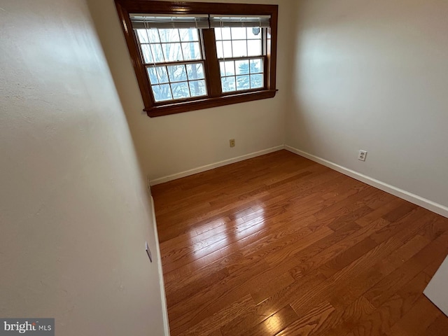 unfurnished room with wood-type flooring