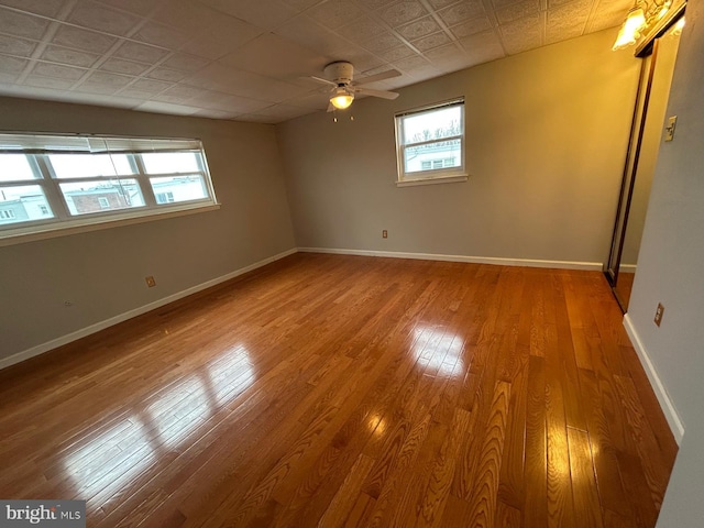 unfurnished room with ceiling fan and wood-type flooring