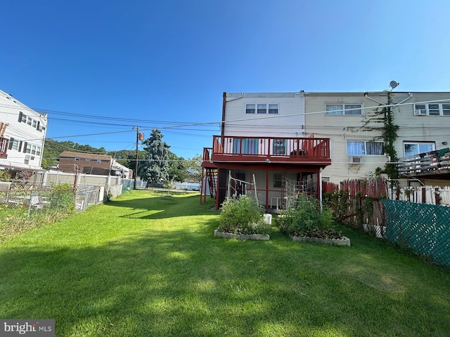 back of property with a lawn and a wooden deck