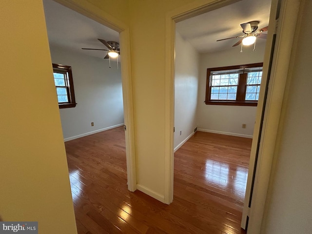 empty room with ceiling fan and wood-type flooring