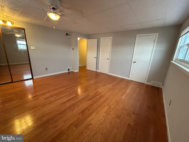 unfurnished bedroom featuring ceiling fan and wood-type flooring