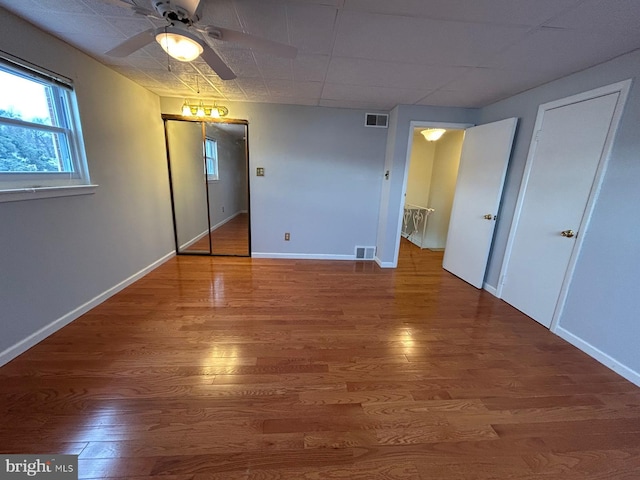 unfurnished bedroom featuring hardwood / wood-style floors and ceiling fan