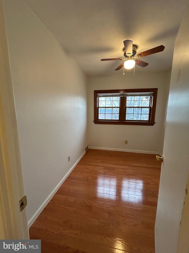 spare room featuring ceiling fan and hardwood / wood-style floors