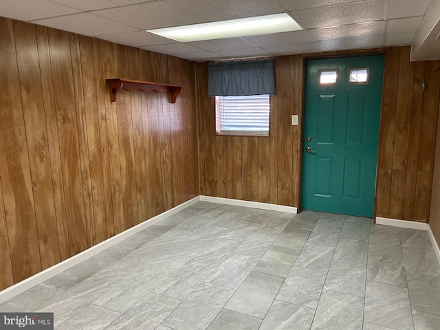 foyer featuring wood walls