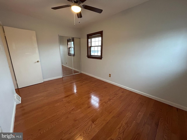 unfurnished bedroom with a closet, ceiling fan, and hardwood / wood-style floors