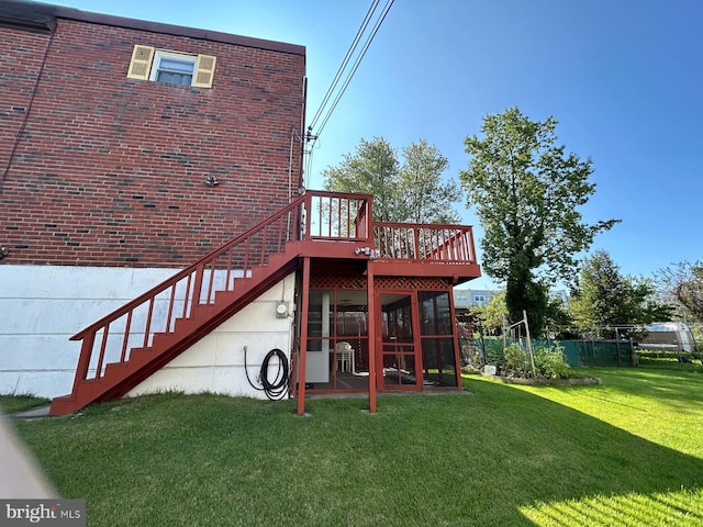 rear view of house featuring a lawn