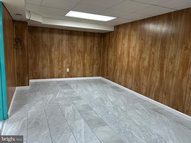 basement featuring wooden walls