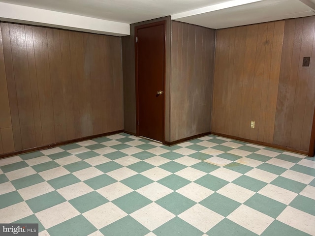 spare room featuring wood walls