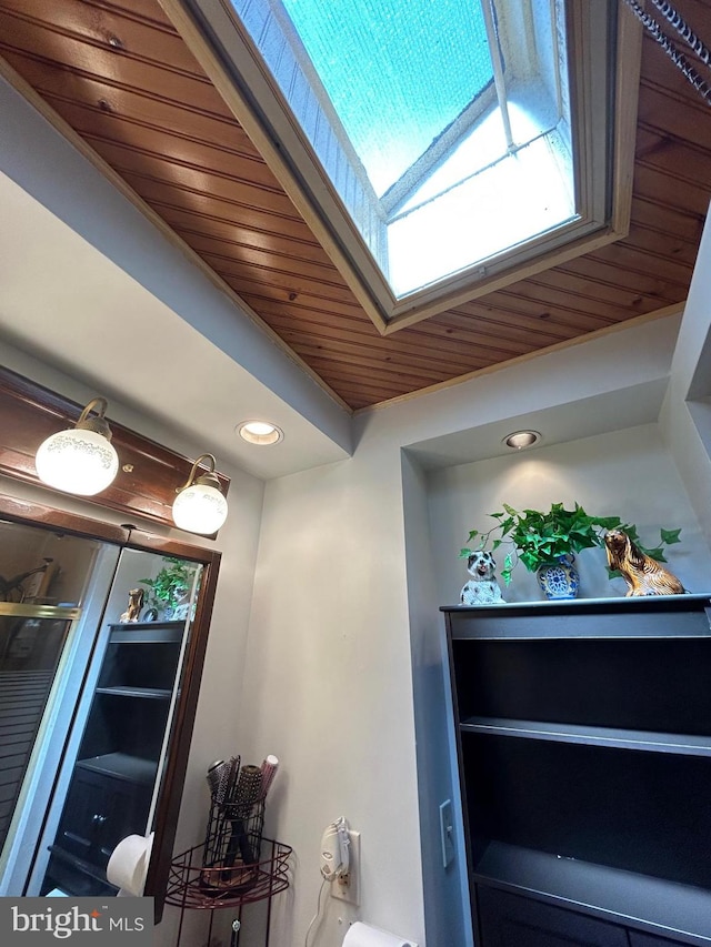 interior space featuring a skylight and wood ceiling