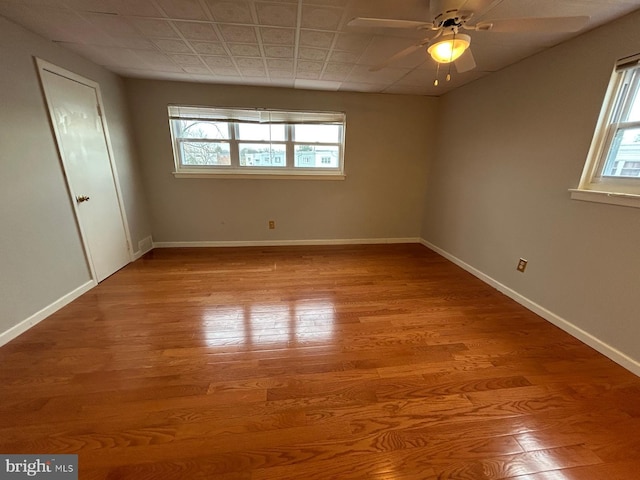 empty room with light wood-type flooring and ceiling fan