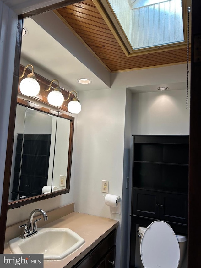 bathroom with vanity, wooden ceiling, and a skylight