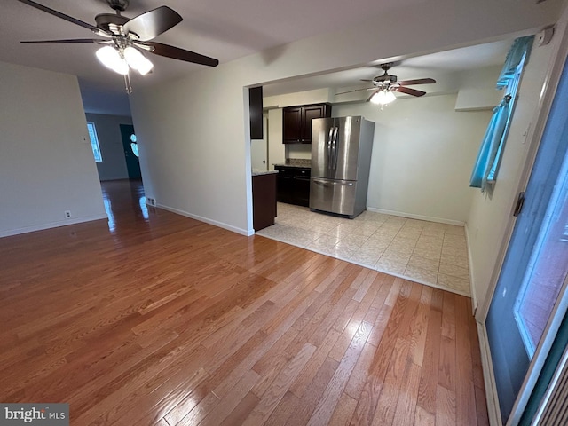 unfurnished living room with ceiling fan and light hardwood / wood-style floors