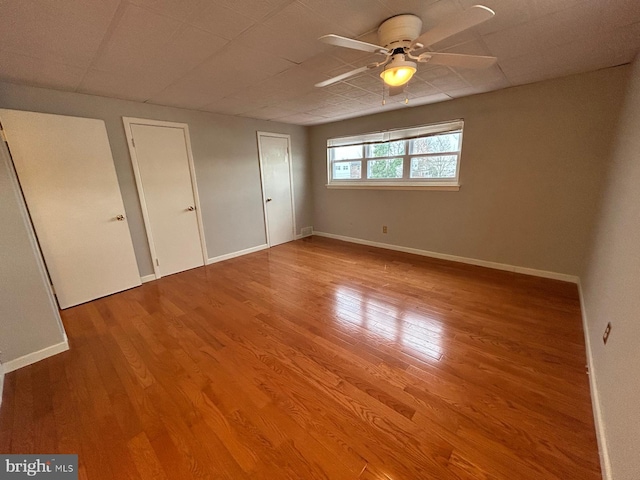 unfurnished room featuring hardwood / wood-style floors and ceiling fan