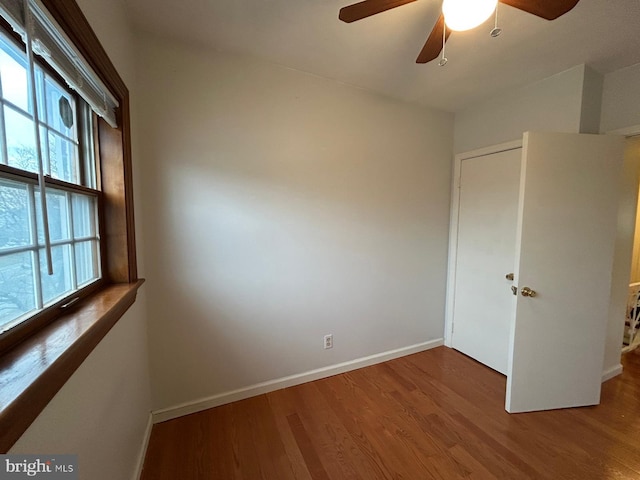 unfurnished bedroom with ceiling fan and wood-type flooring