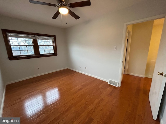 spare room with ceiling fan and wood-type flooring