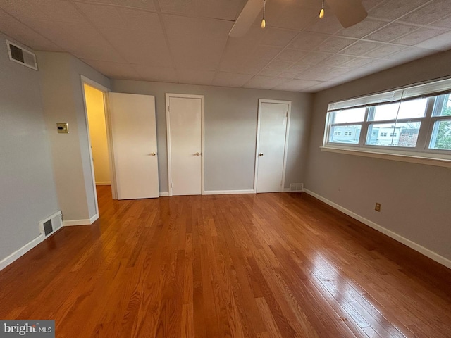 unfurnished bedroom with ceiling fan and wood-type flooring