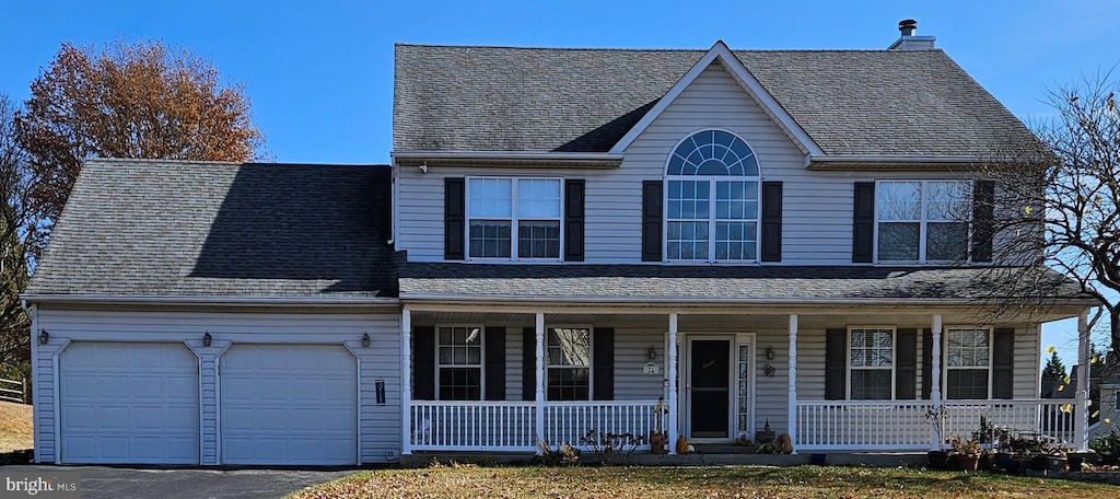 view of front facade featuring a garage and covered porch