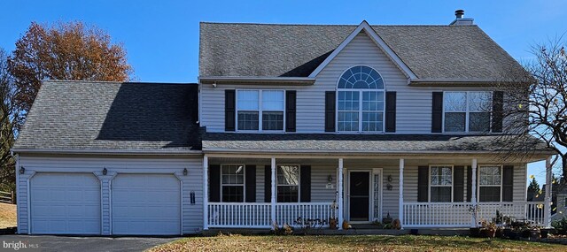 view of front facade featuring a porch and a garage