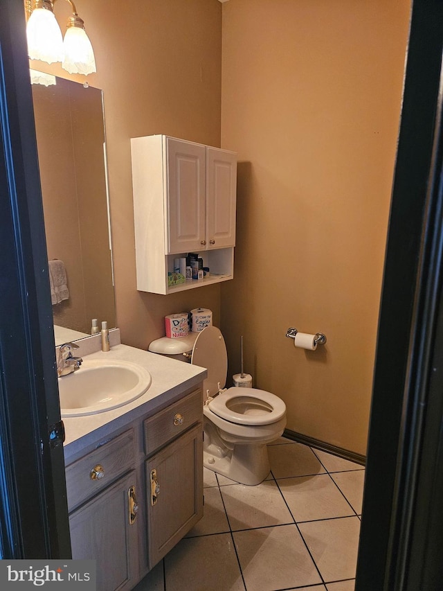 bathroom featuring tile patterned floors, toilet, and vanity