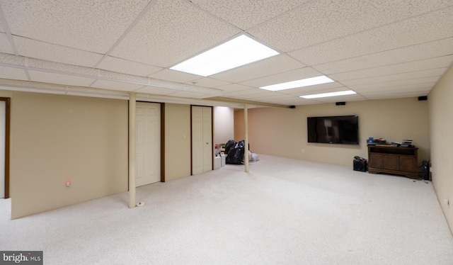 basement featuring carpet and a drop ceiling