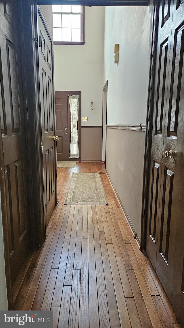 interior space featuring light hardwood / wood-style floors and a high ceiling