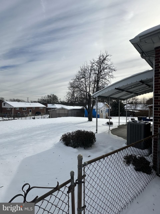 yard layered in snow with central AC