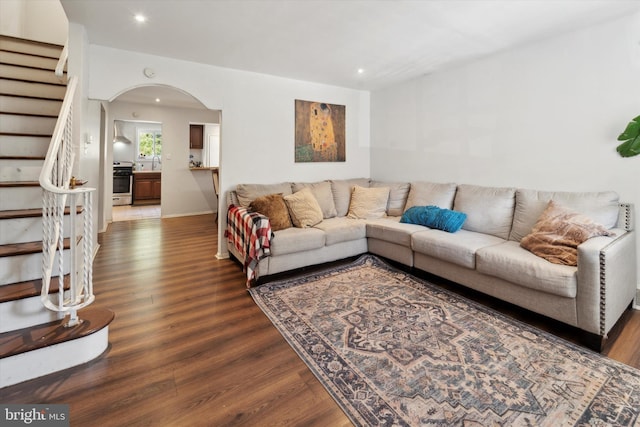 living room with dark hardwood / wood-style floors and sink