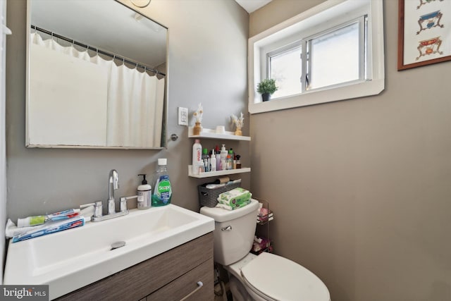 bathroom featuring vanity and toilet