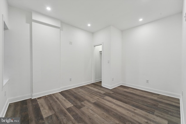 empty room featuring dark wood-type flooring