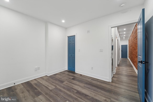 spare room with dark wood-type flooring