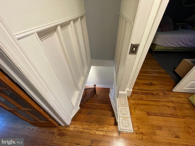 staircase featuring wood-type flooring