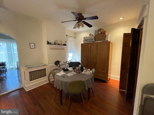 dining space with ceiling fan, dark hardwood / wood-style flooring, and crown molding