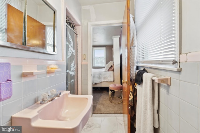 bathroom with sink and tile walls