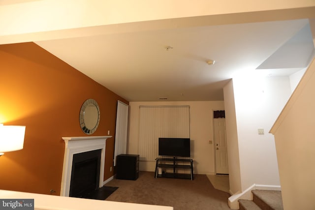 carpeted living room with lofted ceiling