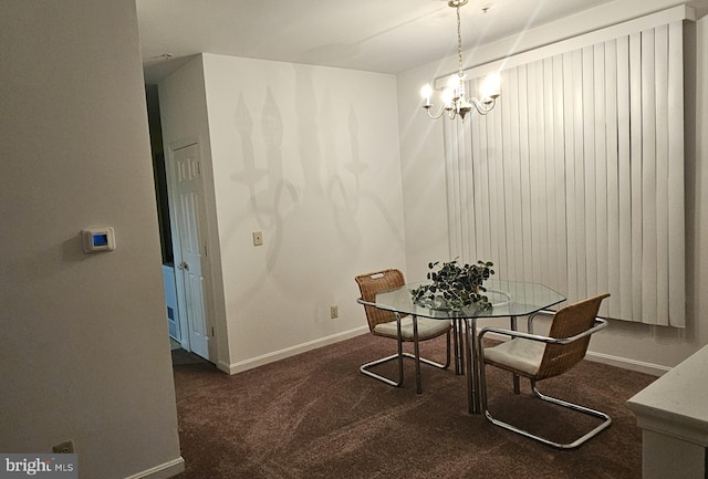 dining area featuring dark carpet and a notable chandelier