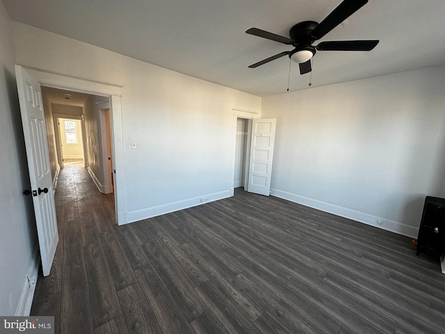 unfurnished bedroom featuring dark hardwood / wood-style flooring and ceiling fan