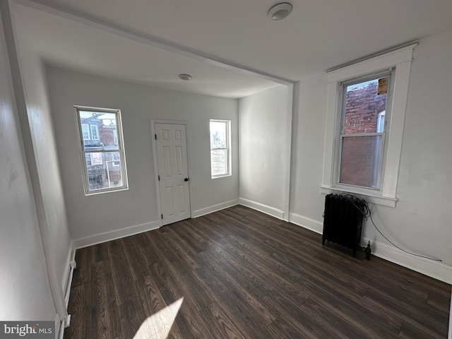 foyer with dark hardwood / wood-style flooring and radiator heating unit