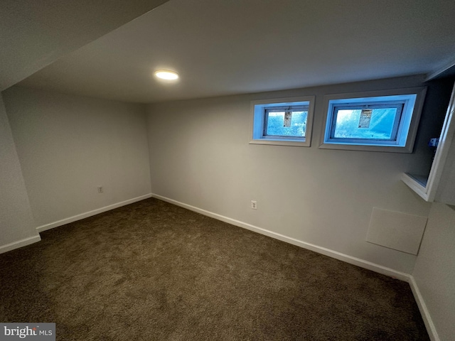 basement featuring dark colored carpet